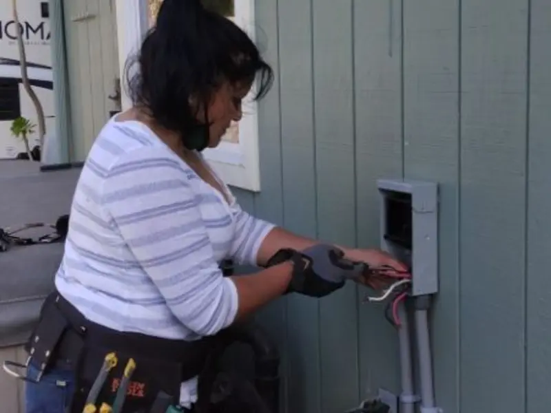Licensed electrician wiring an exterior subpanel in Fairbury
