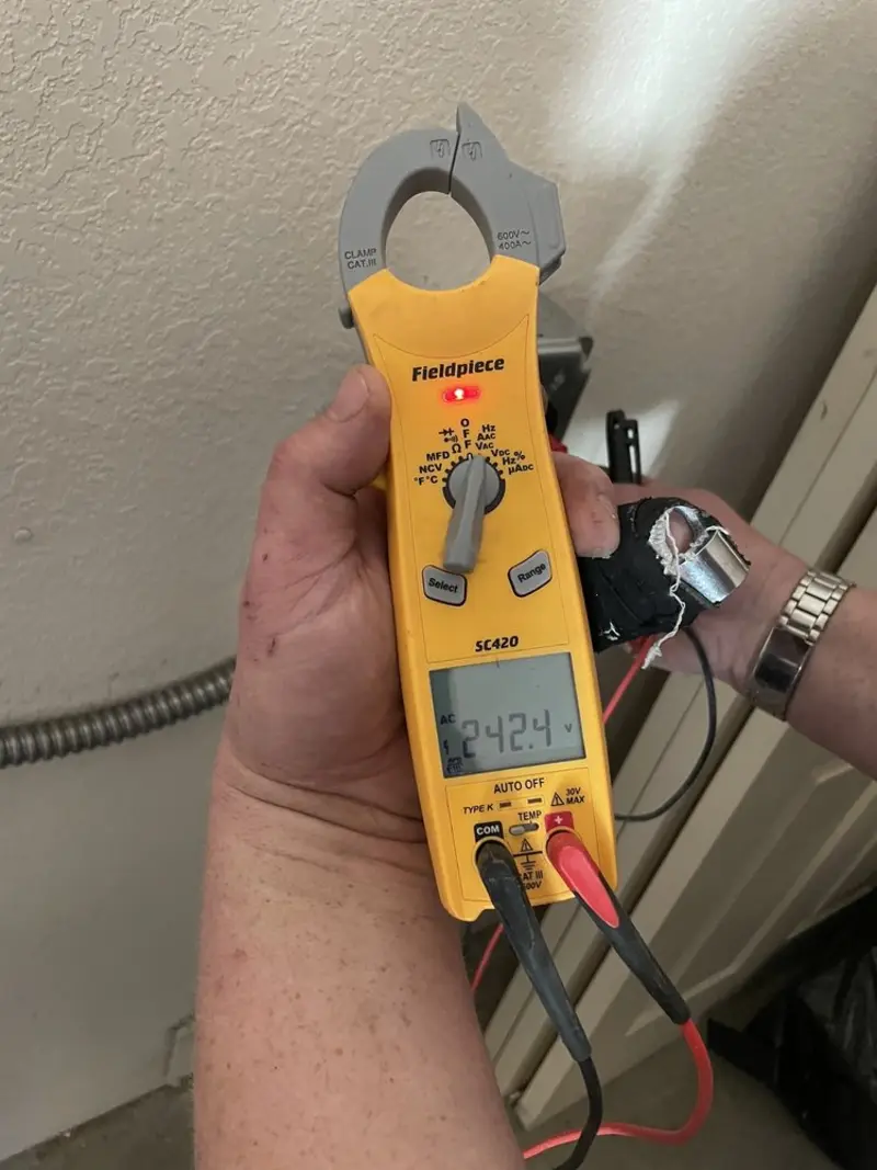Voltage testing with clamp meter during Recessed Lighting Installation in Fairbury